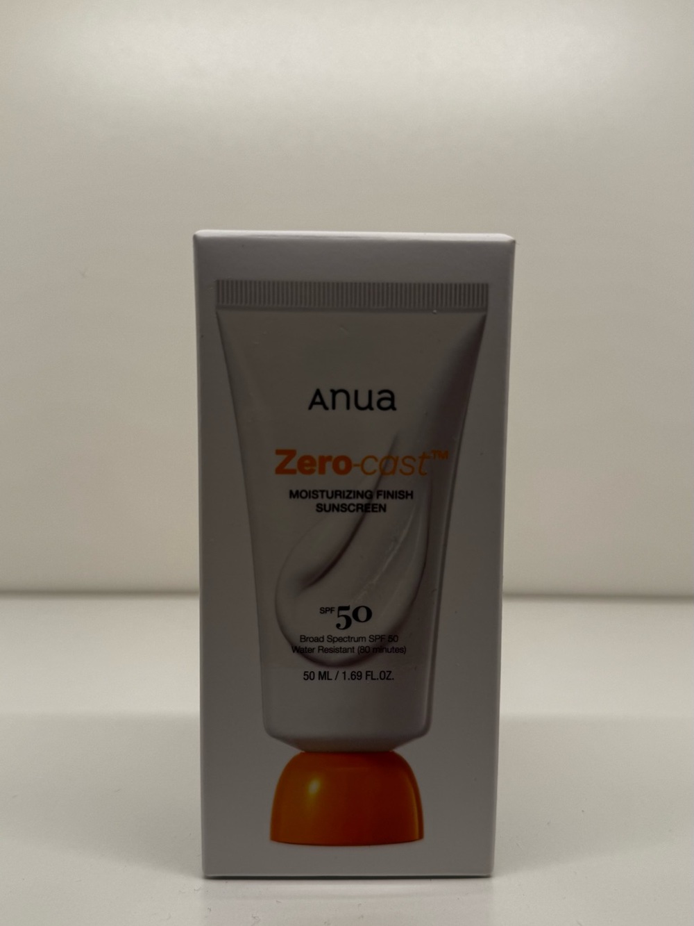 Anua Zero-cast Moisturizing Finish Sunscreen SPF 50 — White with Orange Accent